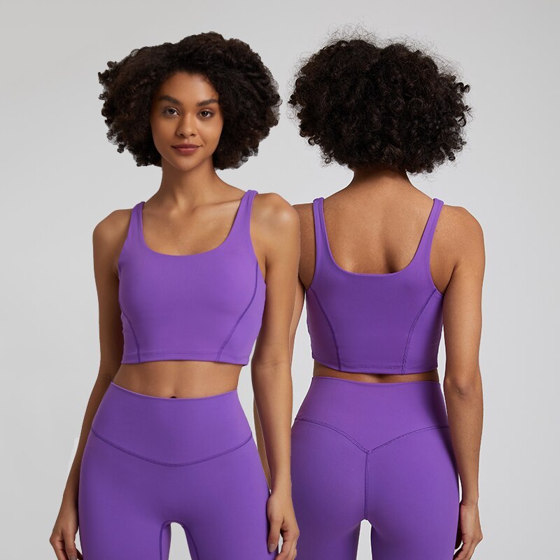 Woman wearing a purple sports bra and leggings set, facing front and back.